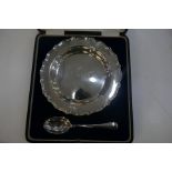 A cased silver circular dish hallmarked Birmingham 1922 Adie Brothers Ltd and a spoon to match 6.24o