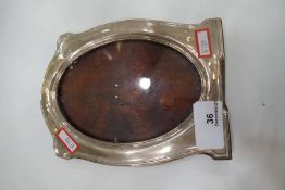 A silver photoframe hallamrked Chester 1913. Of oval form 19cm x 14cm approx