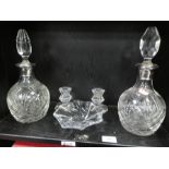 Two similar decanters, a Baccarat glass bowl and a pair of Baccarat squat candlesticks