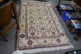 A part silk rug having geometric design in a cream field, 185 x 126cm