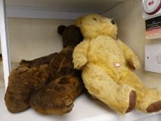 An old plush teddy, two other teddies and sundry