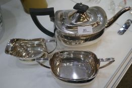 A silver high quality tea service comprising of a heavy tea pot, a two handled sugar bowl and a milk