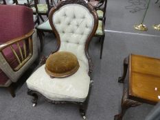 A Victorian carved walnut nursing chair having button back and a Victorian mahogany circular footsto