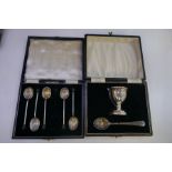 A cased silver egg cup and spoon hallmarked Birmingham 1957-58 Larsson Ltd. Also with a cased set of