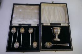 A cased silver egg cup and spoon hallmarked Birmingham 1957-58 Larsson Ltd. Also with a cased set of