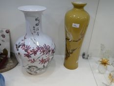 Two modern oriental vases decorated with birds and foliage, both with writing