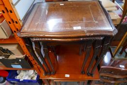 A glazed leather top nest of tables