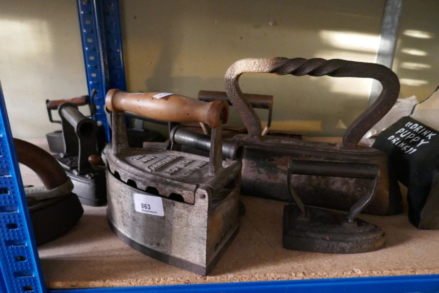 Large selection of Victorian flat irons, mostly branded and a wooden handled version