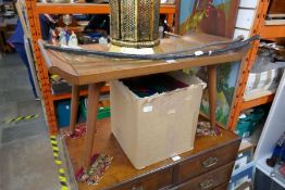 A carved camphor wood coffee table with glazed top