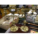 A pair of thee sconce brass candlesticks having engraved central bowls