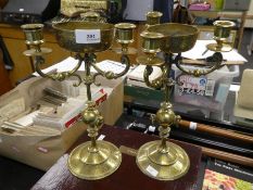 A pair of thee sconce brass candlesticks having engraved central bowls