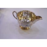 A matching silver sugar bowl and a creamer on a raised pedestal foot and foliate handles. Nice shape