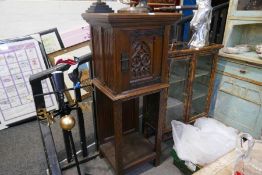 A carved oak cupboard of ecclesiastical style with shelf below