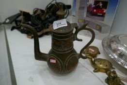 A brass and copper Islamic decorative coffee pot