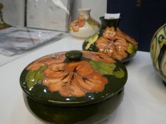 A moorcroft squat vase having orange flowers and a matching circular dish with lid