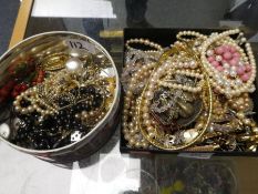 Tray and tin of mixed costume jewellery to include pearl necklaces, silver pieces etc