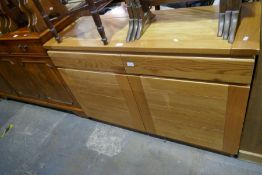 A modern oak sideboard having two drawers and cupboards below