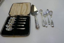 A set of five silver Sheffield 1946 H Hunt, along with a silver handled decorative pie slice and fou