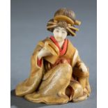 Ivory okimono of a sitting woman in a kimono.
