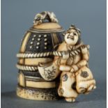Ivory netsuke of a man tied to a bell.