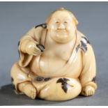 Ivory netsuke of a sitting sumo wrestler.