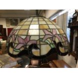 A leaded glass hanging light with ribbed ceiling rose and chain supporting scalloped bowl shaped