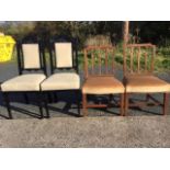 A pair of antique elm dining chairs with lathe backs above stuffover upholstered seats, raised on