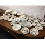 A Royal Worcester Bernina pattern porcelain dinner service with coffee set, all decorated with