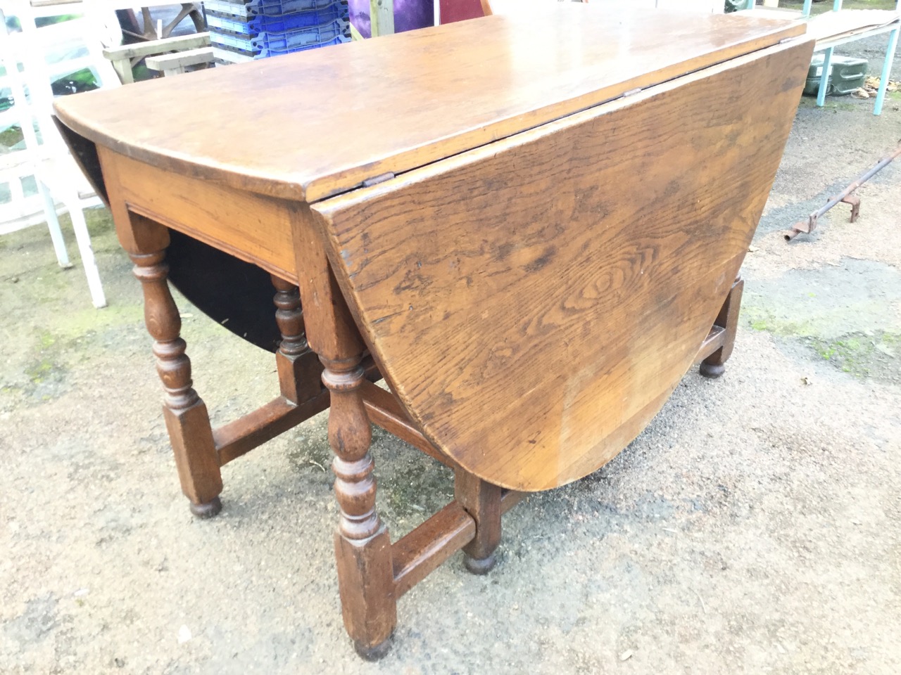 An oval oak dining table, the top with two drop leaves supported on baluster turned columns joined - Image 3 of 3