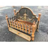 A cast iron dog grate, having arched back cast with urn and swags behind a rectangular grill box,