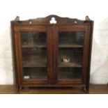 A late nineteenth century stained hanging wall cupboard, the top shelf with pierced back above