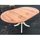 A yew dining table, the crossbanded top with ribbed edge having drop-leaves, raised on column with
