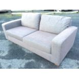 A contemporary upholstered Marks & Sparks sofa with loose cushions and rectangular platform arms,