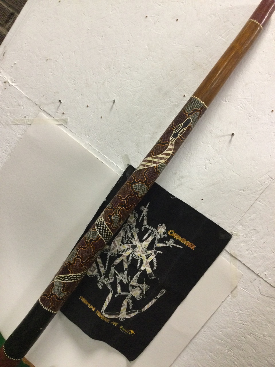 A tapering Indonesian Aboriginal didgeridoo, with painted and enamelled decoration of snake to body;