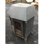 A cast iron wood/solid fuel stove with angled glazed doors having fitted back boiler, raised on