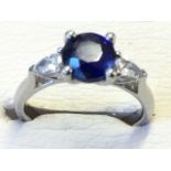An 18ct white gold sapphire & diamond ring, the circular claw set sapphire of over one-and-and-