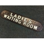 A cast iron sign from Akeld Station the rectangular rounded panel reading Ladies Waiting Room. (21.