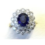 An 18ct yellow gold sapphire & diamond ring, the oval claw set sapphire of over two-and-a-half