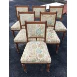 A set of six late Victorian oak dining chairs with floral brocade upholstery, the backs with moulded