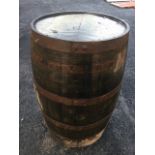 An old oak whiskey barrel, the staves bound by five metal strap bands. (35in)