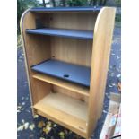 A modern roll-top oak desk, the tambour enclosing an interior with two sliding shelves above an