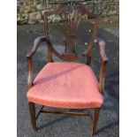 A Hepplewhite style mahogany armchair, the shield shaped back having pierced scrolled splat carved