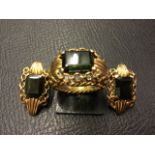 A gold wirework ring & earring set, with rectangular dark green stones, the ring with central rib
