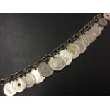 A silver coloured bracelet mounted with fifteen foreign coins - øre, some Victorian, dinnas,