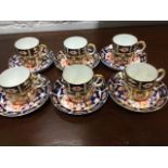 A Royal Crown Derby six-piece coffee set decorated in the traditional brick-red, blue & gilt