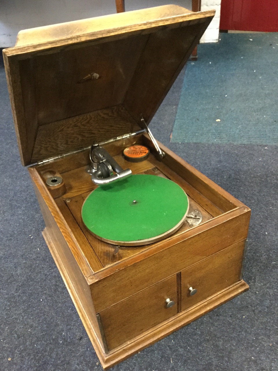 An oak cased His Masters Voice wind-up gramophone, with rectangular moulded top above a cabinet with