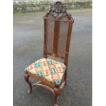A Queen Anne style walnut side chair with pierced scroll carved crest above twin rectangular caned