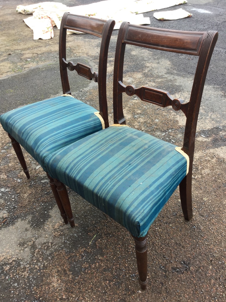 A pair of nineteenth century mahogany chairs with tablet panelled back rails on ribbed stiles, the