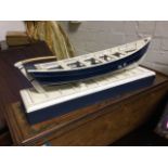 A handbuilt model of a Northumbrian cobble, the clinker built boat on rectangular moulded stand. (