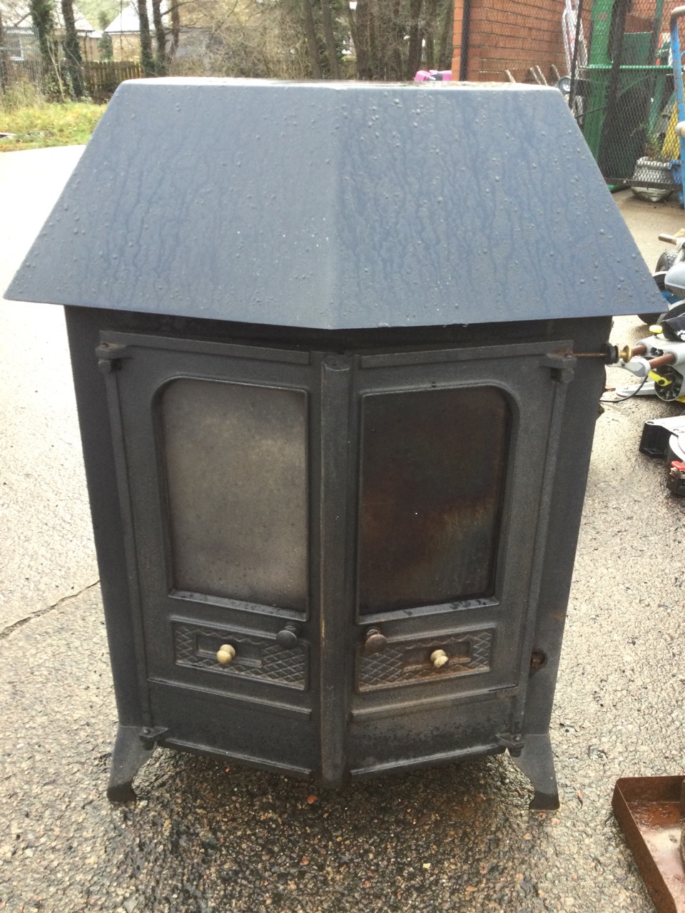 A cast iron wood/solid fuel stove with angled glazed doors having fitted back boiler, raised on - Image 2 of 3